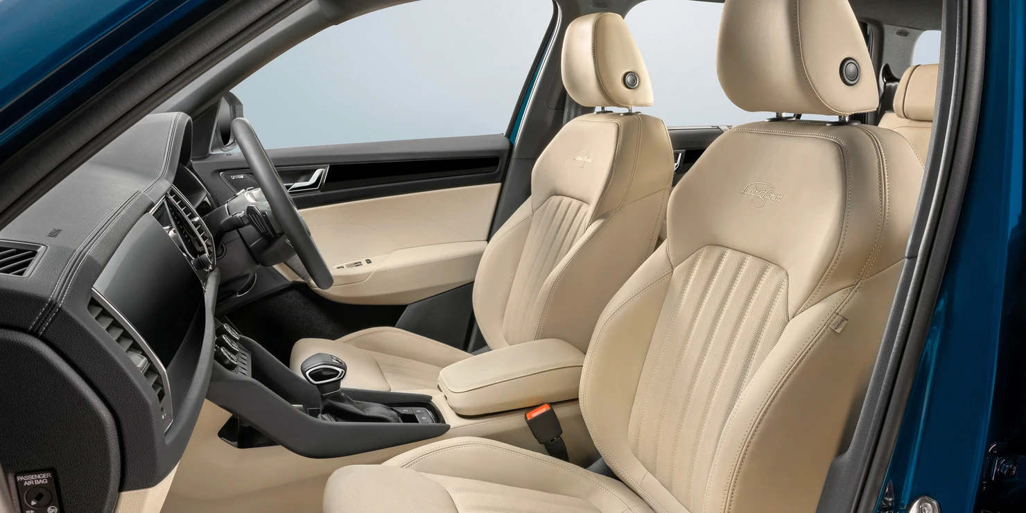 The stone beige upholstery comes in perforated leather with the L&K logo embroidered on the front seats.